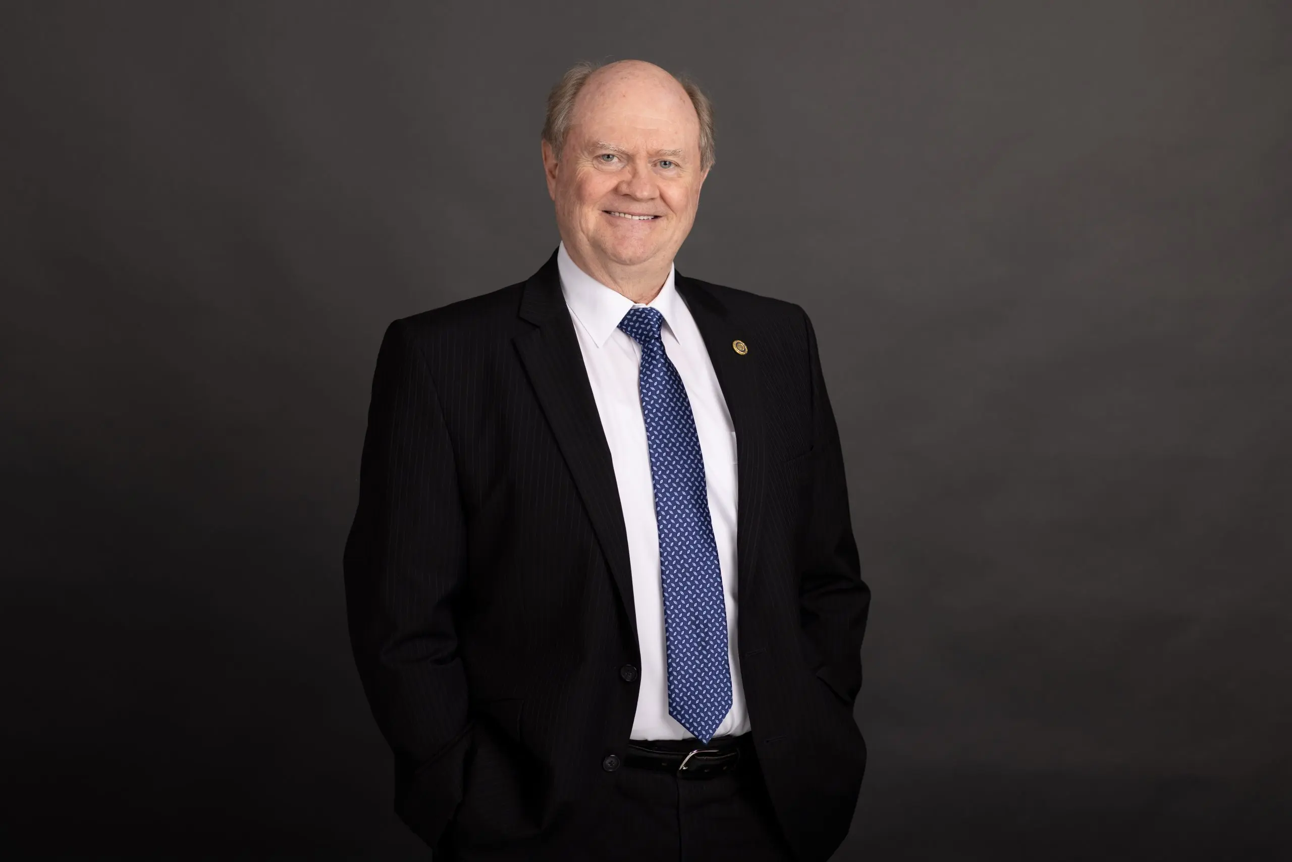 Rob Ffrench in a black suit and blue tie